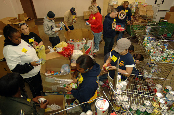 us_navy_sailors_sort_through_food_items_checking_expiration_dates_while_volunteering_at_the_food_bank_of_southeastern_virginia